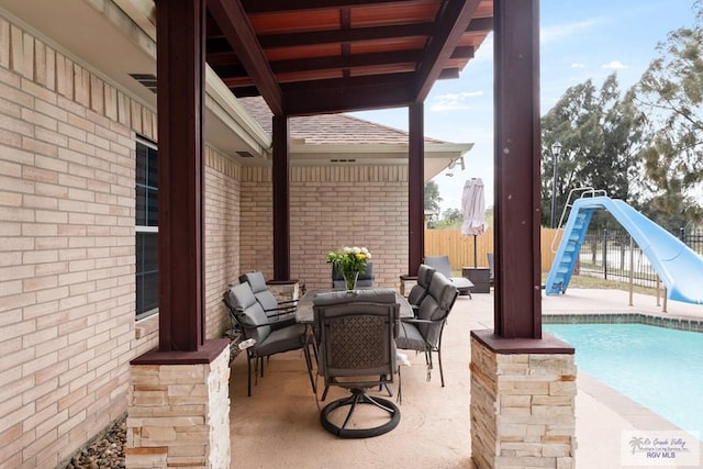 view of patio / terrace with a fenced in pool and fence