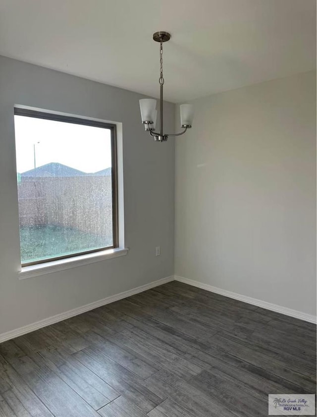 unfurnished dining area featuring a mountain view, a notable chandelier, and dark hardwood / wood-style flooring