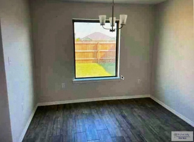 unfurnished dining area with dark hardwood / wood-style floors and a chandelier