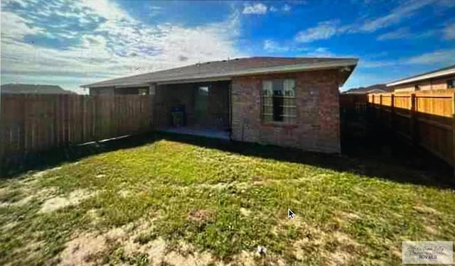 rear view of property with a lawn