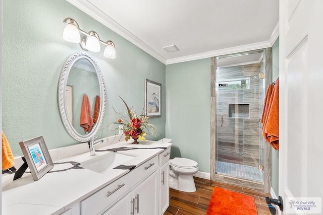 full bath featuring toilet, a stall shower, vanity, crown molding, and wood tiled floor