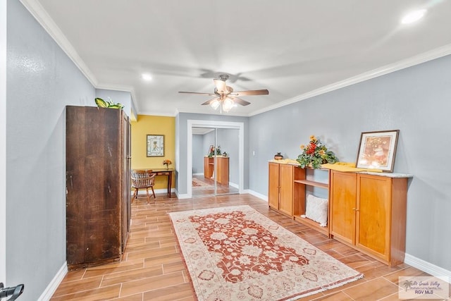 interior space with ornamental molding, a ceiling fan, baseboards, and wood tiled floor