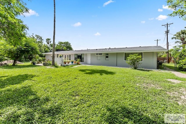 back of property with a yard and fence