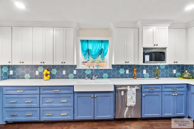 kitchen featuring a sink, light countertops, blue cabinets, and stainless steel appliances