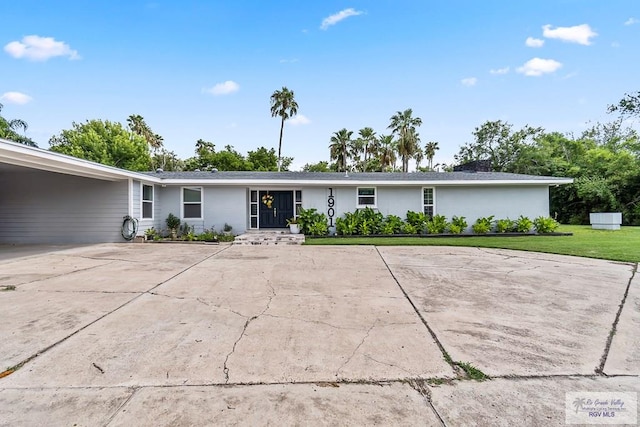 single story home featuring a carport and a front lawn