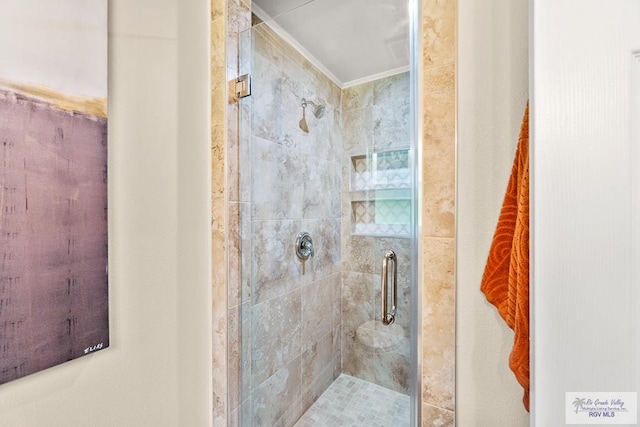 bathroom with a stall shower and ornamental molding