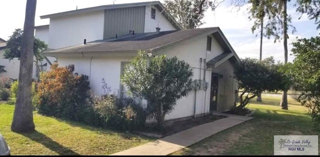 view of side of property with a lawn