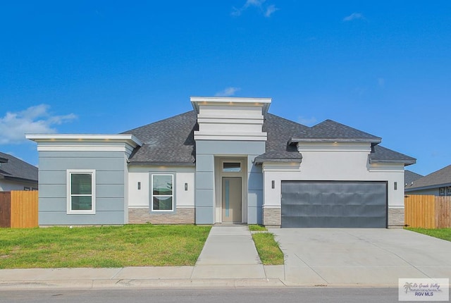 view of front of home featuring a front yard and a garage