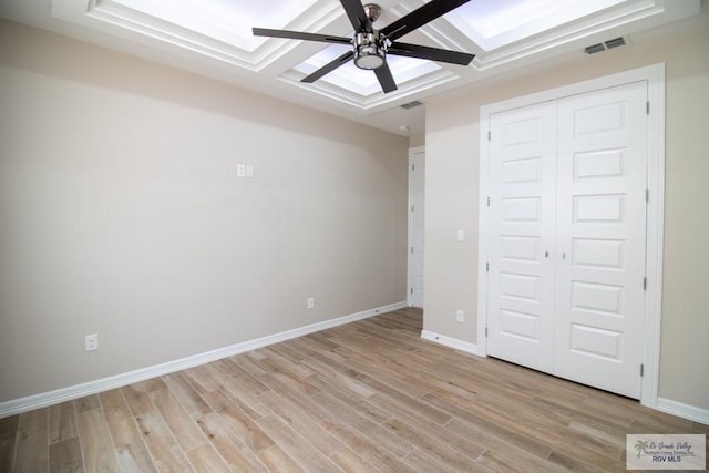 unfurnished bedroom with a closet, light hardwood / wood-style floors, and ceiling fan