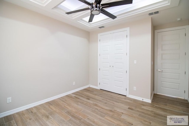 unfurnished bedroom with a closet, light hardwood / wood-style floors, and ceiling fan