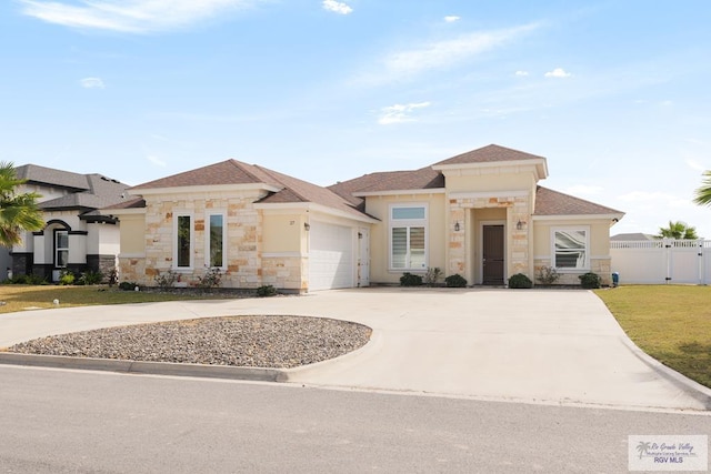 view of front of home with a garage and a front lawn