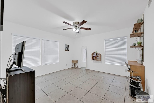 living room featuring light tile patterned floors and ceiling fan