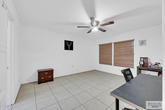 unfurnished office with ceiling fan and light tile patterned floors