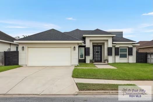 prairie-style house featuring a front yard and a garage