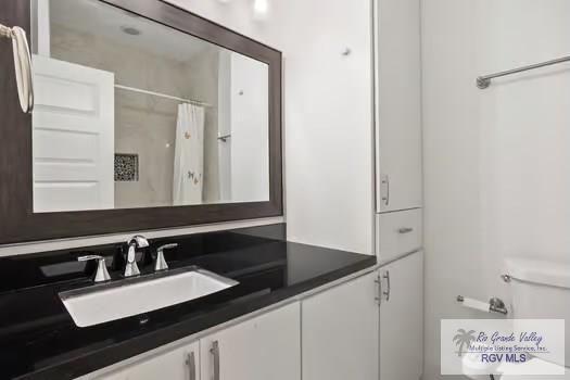 bathroom with vanity and a shower with shower curtain