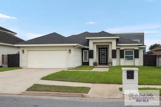 prairie-style home featuring a front yard and a garage