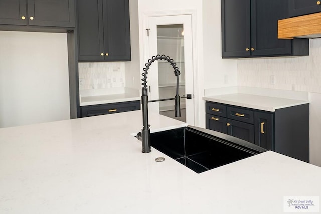 2409 Brown Pelican Ln, Harlingen, TX 78552 - kitchen with tasteful backsplash, exhaust hood, and light countertops
