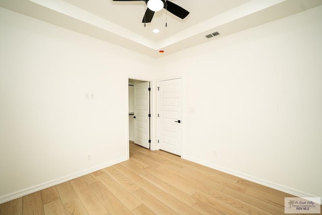 2409 Brown Pelican Ln, Harlingen, TX 78552 - unfurnished room featuring light wood-style floors, a ceiling fan, recessed lighting, and a raised ceiling