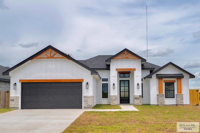 2409 Brown Pelican Ln, Harlingen, TX 78552 - modern farmhouse with stone siding, a garage, concrete driveway, and roof with shingles