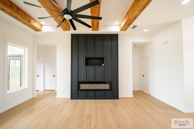 2409 Brown Pelican Ln, Harlingen, TX 78552 - unfurnished living room with light wood-type flooring, beam ceiling, a large fireplace, recessed lighting, and a ceiling fan