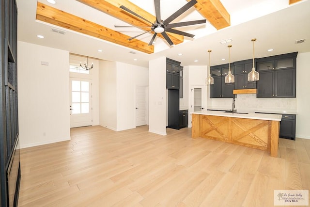 2409 Brown Pelican Ln, Harlingen, TX 78552 - kitchen with recessed lighting, backsplash, ceiling fan, light wood-style floors, and light countertops