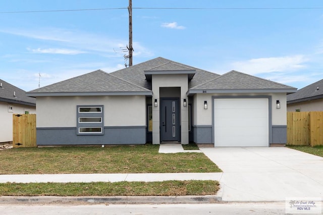 prairie-style home featuring an attached garage, fence, driveway, and roof with shingles