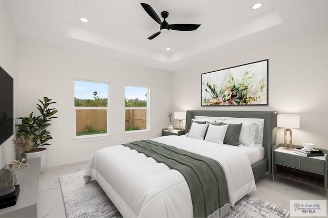 bedroom with recessed lighting, a raised ceiling, marble finish floor, and ceiling fan