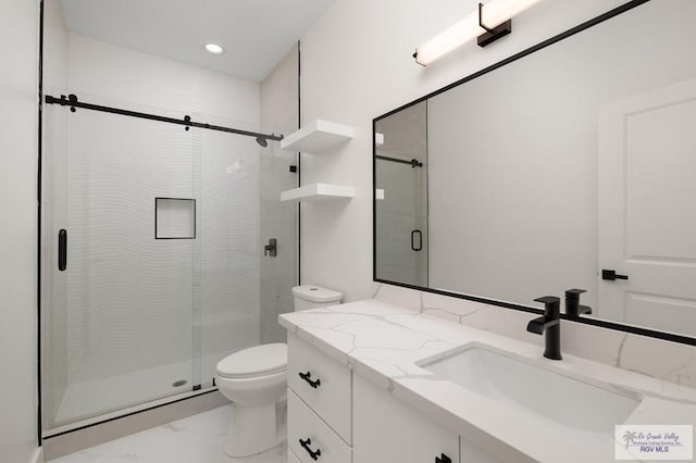 full bath featuring vanity, toilet, a stall shower, and marble finish floor