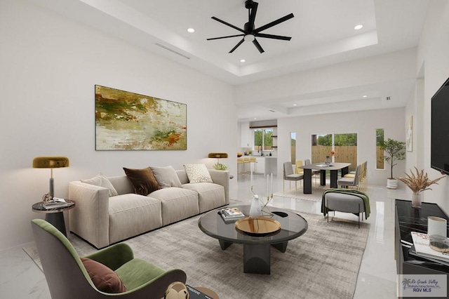 living room featuring visible vents, ceiling fan, recessed lighting, marble finish floor, and a raised ceiling