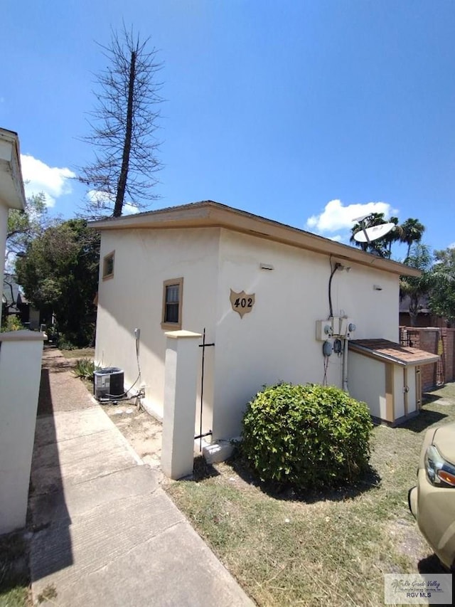 view of side of property with central AC unit