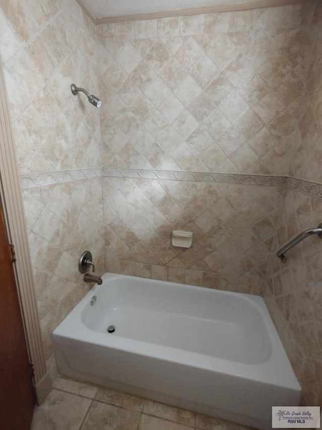 bathroom with tile patterned floors and a tub