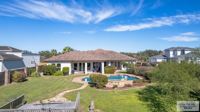 4329 Waters Edge, Harlingen, TX 78550 - back of property featuring a swimming pool with hot tub, a patio area, and a yard