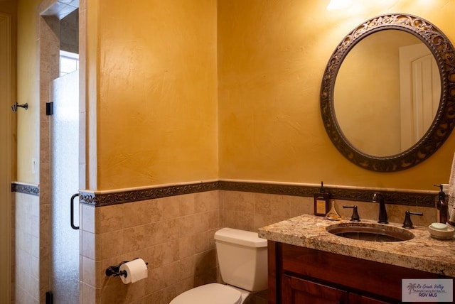 4329 Waters Edge, Harlingen, TX 78550 - bathroom with toilet, tile walls, and vanity