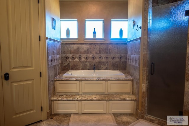 4329 Waters Edge, Harlingen, TX 78550 - bathroom with tile walls and separate shower and tub