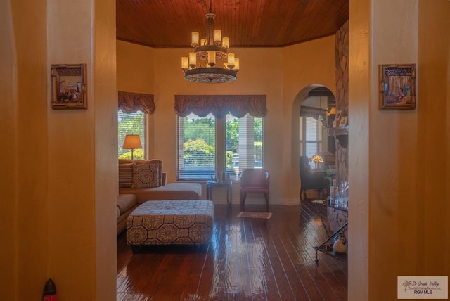 sitting room featuring dark hardwood / wood-style floors, a notable chandelier, and wooden ceiling