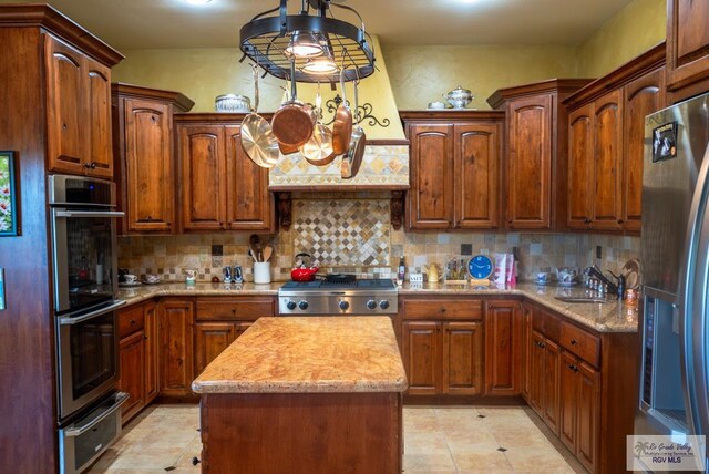 4329 Waters Edge, Harlingen, TX 78550 - kitchen with tasteful backsplash, a kitchen island, sink, hanging light fixtures, and stainless steel appliances
