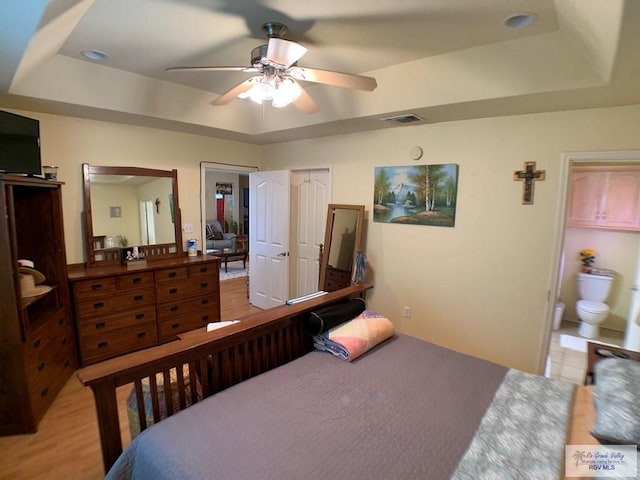 14022 Whitewing Ln, Lyford, TX 78569 - bedroom featuring a raised ceiling, a ceiling fan, and ensuite bathroom