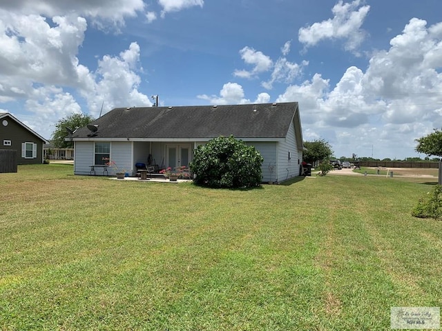 14022 Whitewing Ln, Lyford, TX 78569 - rear view of property featuring a yard, french doors, a patio, and roof with shingles