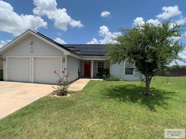 14022 Whitewing Ln, Lyford, TX 78569 - ranch-style house featuring a garage, solar panels, concrete driveway, and a shingled roof