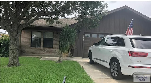 6251 Camelot Dr, Harlingen, TX 78550 - view of side of property with brick siding, a garage, and a lawn
