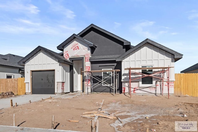 view of front facade with an attached garage and board and batten siding