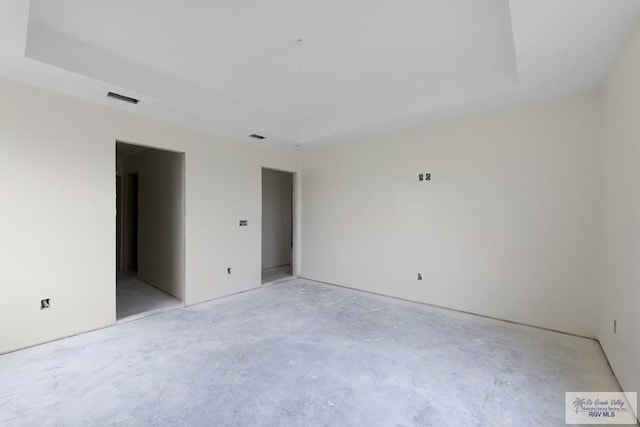 empty room featuring a tray ceiling