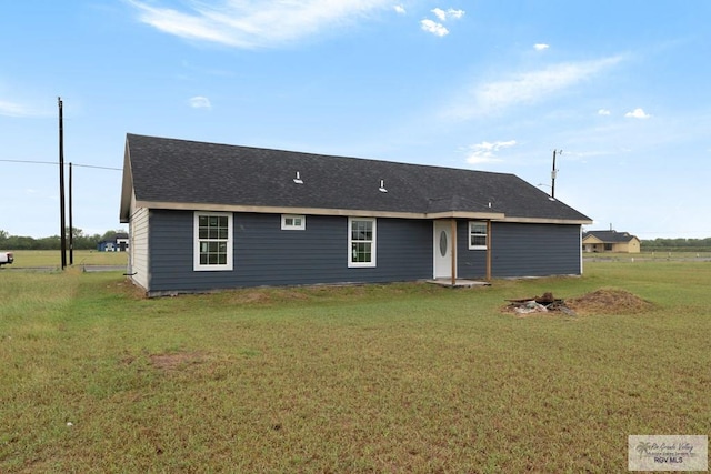 rear view of property with a lawn