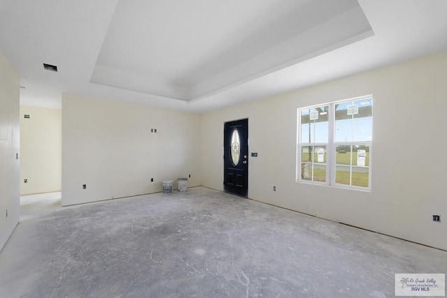 unfurnished room featuring a raised ceiling