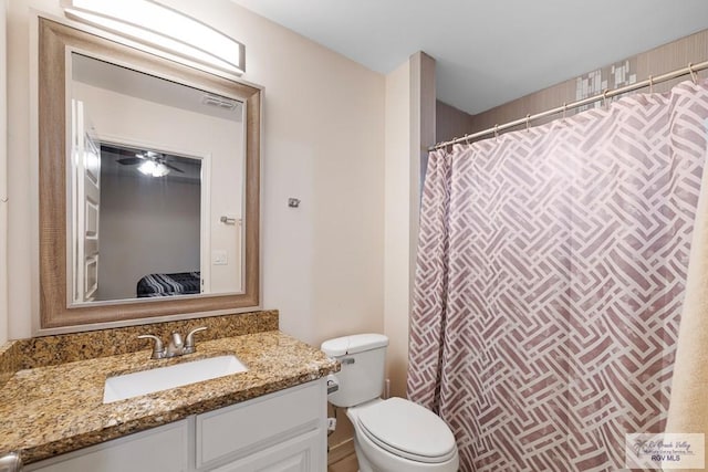 bathroom featuring vanity and toilet