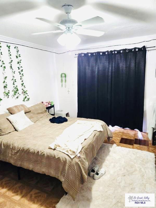 bedroom featuring parquet flooring and ceiling fan