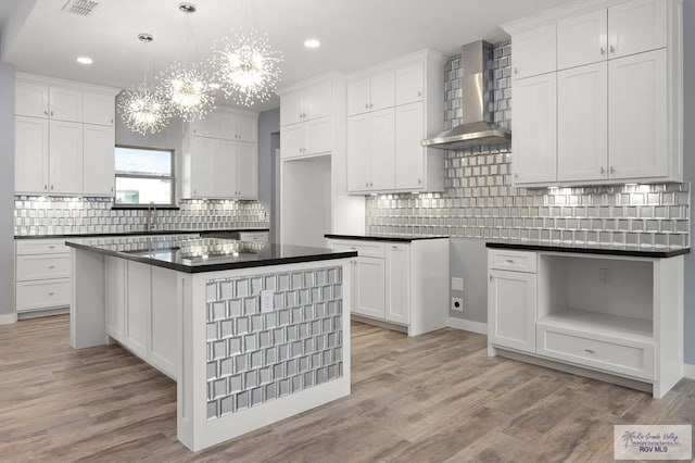 kitchen with recessed lighting, wall chimney range hood, and tasteful backsplash