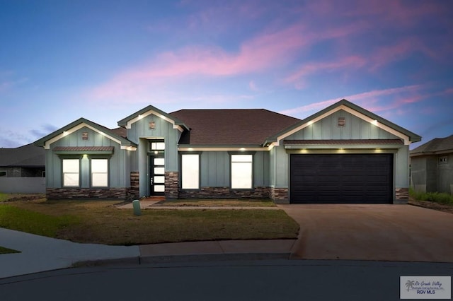 ranch-style house with concrete driveway, stone siding, a garage, and board and batten siding