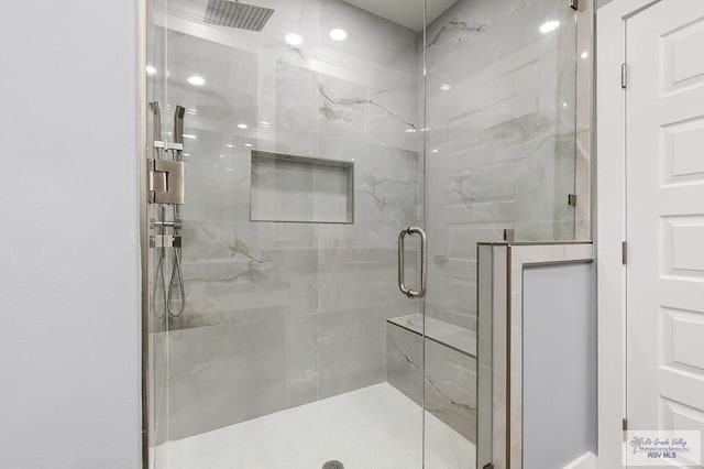 full bath with a marble finish shower