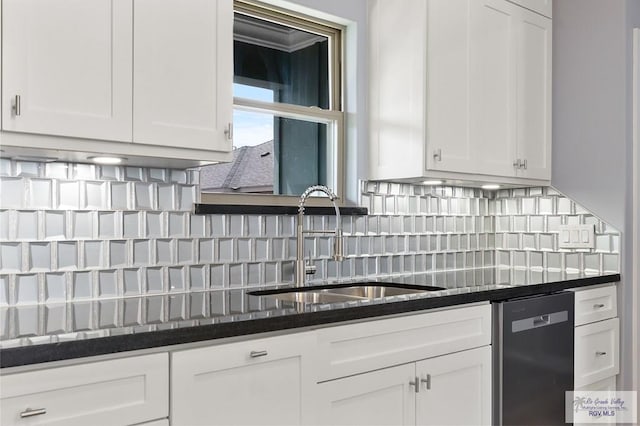 kitchen with white cabinets, dishwasher, decorative backsplash, and a sink